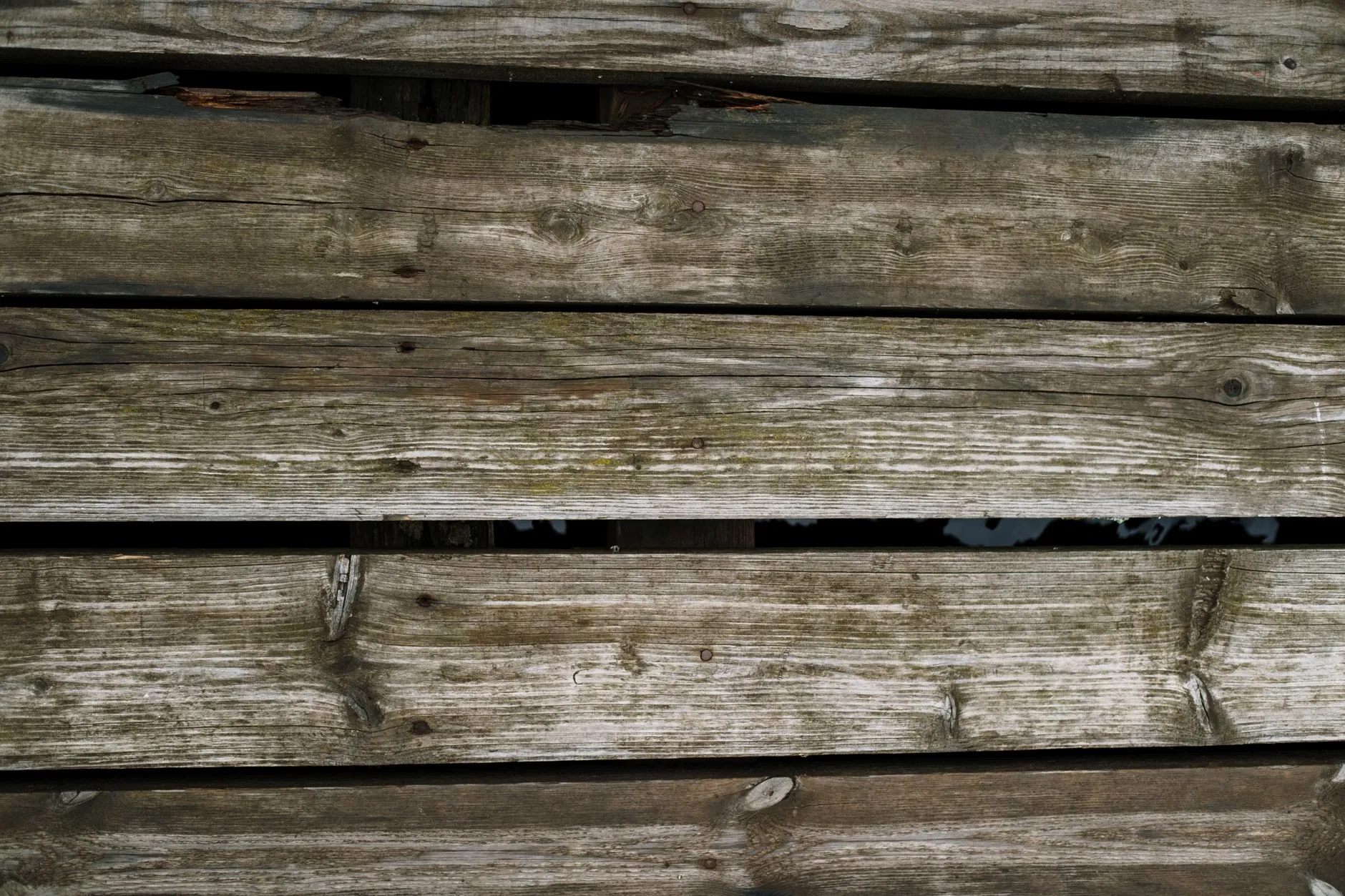 A weathered deck with dirt and mildew buildup before cleaning