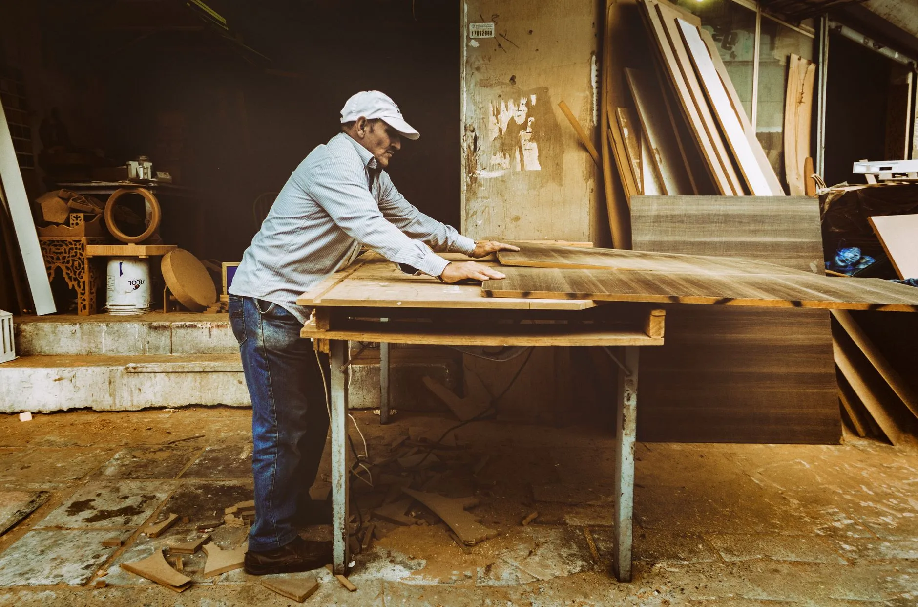 A person building wood furniture in a workshop